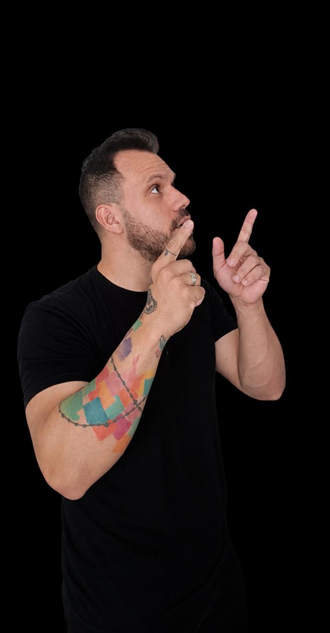 Geison William apontando para cima, em camiseta preta